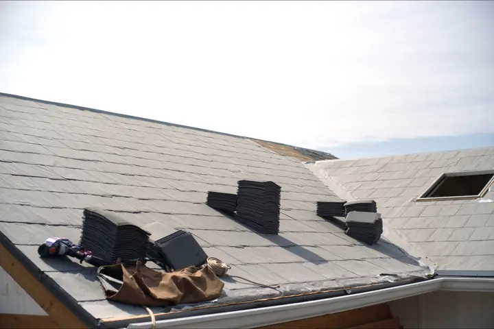 Bundles of shingles stacked on a roof deck part way through a re-roof.