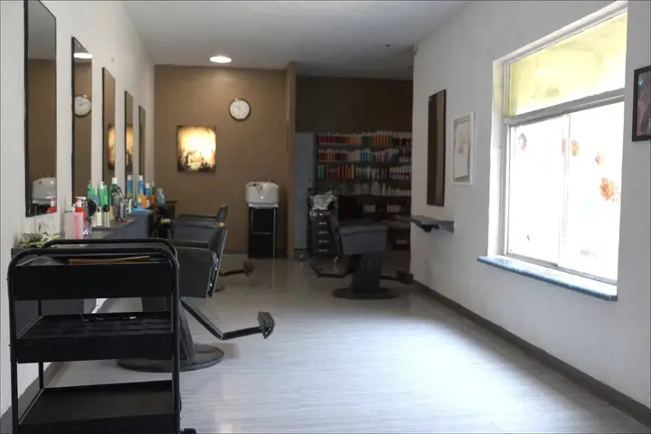 Styling chairs and mirrors in a salon before opening.